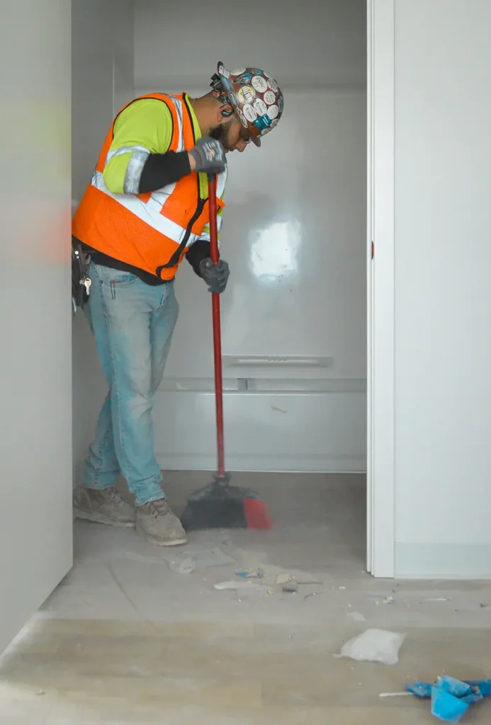 Superior Labor Solutions Employee Sweeping Debris on Floor