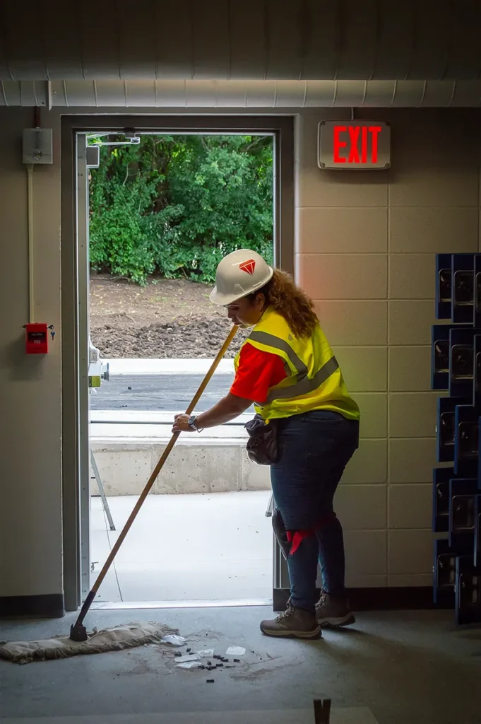 Superior Labor Solutions Employee Sweeping Debris on Floor